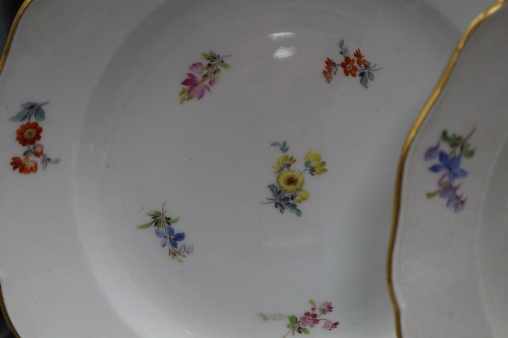 Three Meissen floral and gilt decorated plates, diameter 24cm